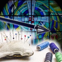 Arrow, pincushion and spools of thread with a stained glass window in the background
