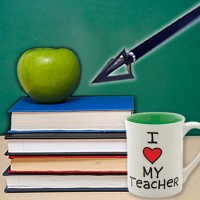 apple, stack of books, teacher's mug and arrow in front of a chalkboard