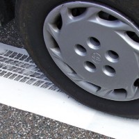 Vehicle tire leaving an inked imprint on white paper