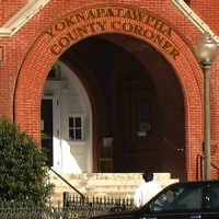 Front entrance of the red brick building housing the Yoknapatawpha County Coroner's Office