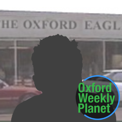 Silhouette of a man with the Oxford Eagle office in the background and the Oxford Weekly Planet logo superimposed