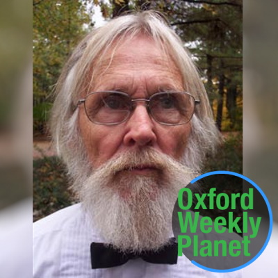 Man with glasses and white hair, beard and mustache with the Oxford Weekly Planet logo in the foreground