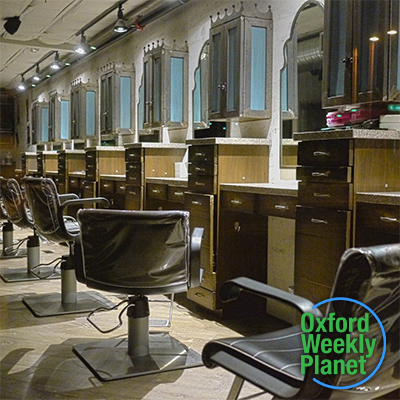 Beauty salon client chairs with the Oxford Weekly Planet logo in the foreground