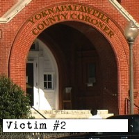Front entrance of the Yoknapatawpha County Coroner's Office with the label "Victim #2" in the foreground