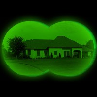 View through night-vision binoculars of a single family residence