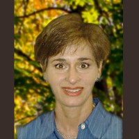 Smiling woman with short brown hair and brown eyes