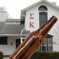 Fraternity house with a beer bottle in the foreground