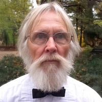 Older man with glasses and white hair, beard and mustache