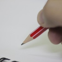 Hand about to write with a pencil