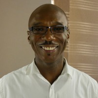 Smiling bald man with glasses