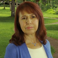 Woman with shoulder-length reddish-brown hair