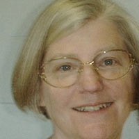 Woman with glasses and a short blonde bob haircut