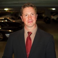 Serious man with short brown hair