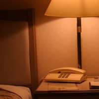 Hotel room bedside table with phone