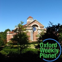 Paris-Yates Chapel at the University of Mississippi with the Oxford Weekly Planet logo in the foreground