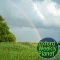 Rainbow over a meadow with the Oxford Weekly Planet logo in the foreground