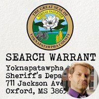 Seal of Yoknapatawpha County with the label 'Search Warrant' and an inset of a clean-shaven man with short blond hair