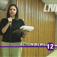 Reporter with microphone in a hallway