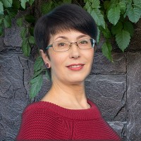 Woman with short dark hair and glasses