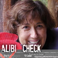Smiling woman with short dark hair with the label "Alibi Check"