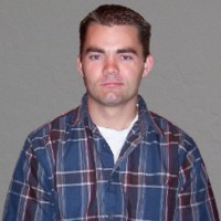 Young man with dark hair and eyebrows