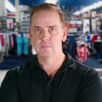 Man with reddish-brown hair in a sporting goods store