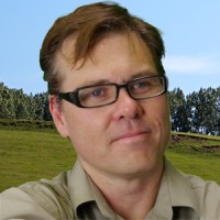 Man with brown hair and dark-rimmed glasses