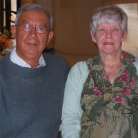 Gray-haired man and woman sitting side by side