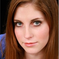 Young woman with long red hair and blue eyes