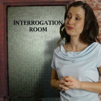 Woman with long dark hair in front of the interrogation room door