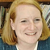 Smiling woman with a strawberry-blonde bob haircut