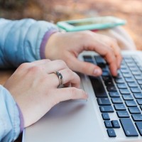 Woman's hands on a laptop keyboard