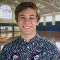 Smiling teen boy with medium brown hair