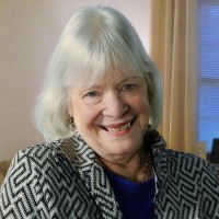 Smiling woman with a white bob haircut