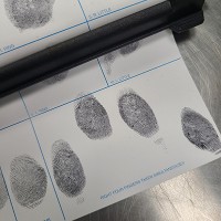 Inked fingerprints on a fingerprint card