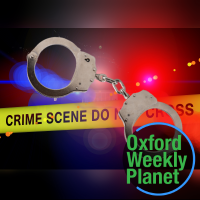 Handcuffs with police lights and crime scene tape in the background and the Oxford Weekly Planet logo in the foreground