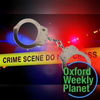 handcuffs with crime scene tape and police lights in the background and the Oxford Weekly Planet logo in the foreground