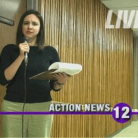 Reporter with microphone in a hallway