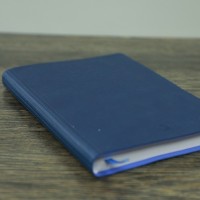 Blue notebook on a wood table