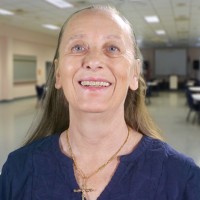 Smiling older woman with light brown hair