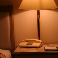 Hotel room bedside table with phone