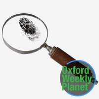 Yellow crime scene tape with the Oxford Weekly Planet logo in the foreground