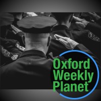 Uniformed law enforcement officers saluting with the Oxford Weekly Planet logo in the foreground