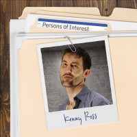 Photo of a sullen man with dark hair and five o'clock shadow, clipped to a manila folder