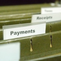 Hanging file folders with tabs labeled "Payments" and "Receipts"