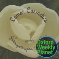 Lamar Cosmetics magnolia blossom logo with the Oxford Weekly Planet logo in the foreground
