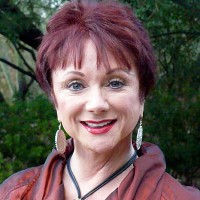 Smiling woman with short auburn hair