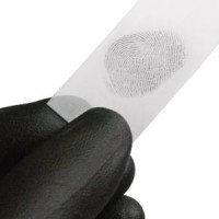 Gloved hand holding a strip of paper with a fingerprint on it