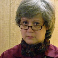 Serious woman with glasses and short salt-and-pepper hair