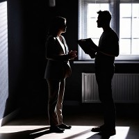 A woman and a man in silhouette having a conversation